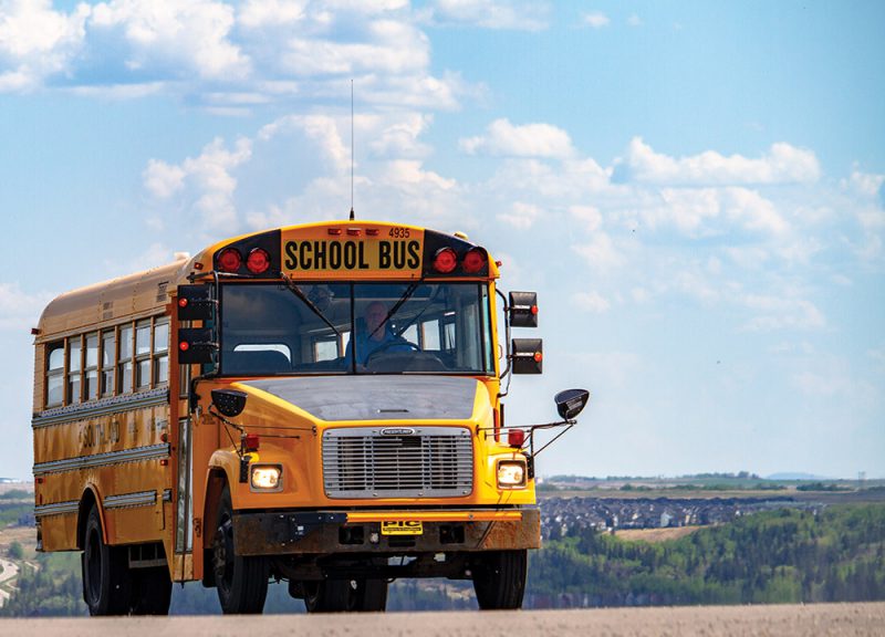 schoolbus driving in semi-rural area